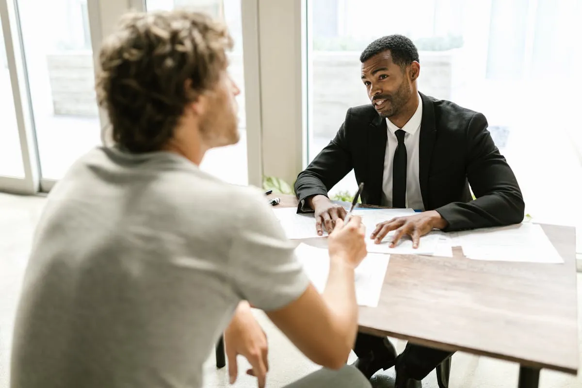 A licensed insurance agent talking with a client across a desk